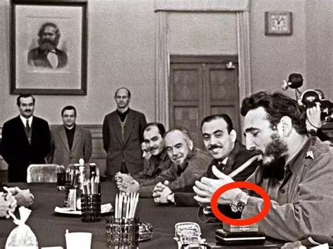 PHOTO: Fidel Castro, wearing two Rolexes, lighting a .